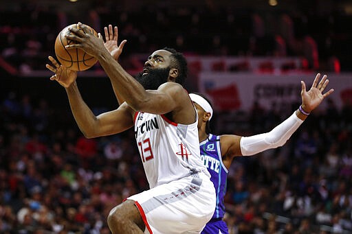 Houston Rockets guard James Harden, left, drives to the basket past Charlotte Hornets guard Devonte' Graham during the second half of an NBA basketball game in Charlotte, N.C., Saturday, March 7, 2020. (AP Photo/Nell Redmond)