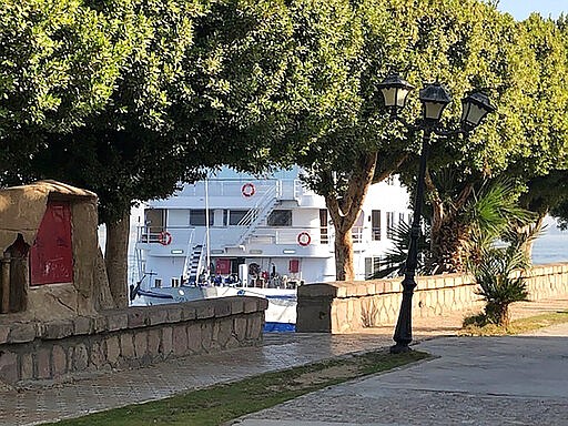 Nile river boat MS River Anuket docks in the city of Luxor in southern Egypt Saturday, March 7, 2020. The ship, carrying some 100 mostly foreign tourists is under quarantine after 12 people tested positive for the new coronavirus. The passengers have been confined to the ship while they await testing by Egyptian health authorities. (AP Photo/Maggie Michael)