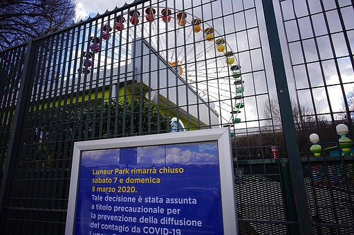 A notice in Italian outside an amusement park in Rome reads 'Luneur Park will be closed on Saturday 7 and Sunday 8 of March, 2020. This decision has been taken to avoid the spread of the COVID-19 contagion', Saturday, Mar. 7, 2020. (AP Photo/Domenico Stinellis)