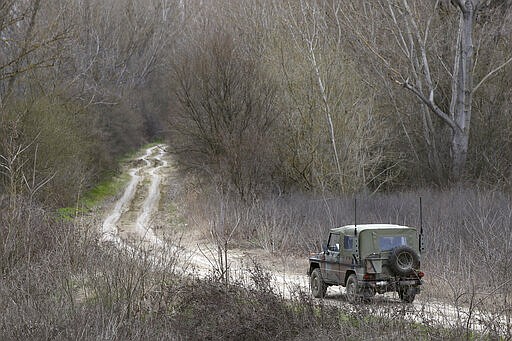 A Greek Army vehicle patrols near the village of Marasia, Greece, on the Greek-Turkish border on Thursday, March 5, 2020. Turkey has vowed to seek justice for a migrant it says was killed on the border with Greece after Greek authorities fired tear gas and stun grenades to push back dozens of people attempting to cross over. Greece had denied that anyone was killed in the clashes. (AP Photo/Giannis Papanikos)