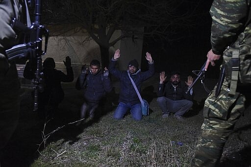 Greek Army arrest migrants in the village of Kastanies, Evros region, near the Greek-Turkish border on Friday, March 6, 2020. Thousands of refugees and other asylum-seekers have tried to enter Greece from the land and sea in the week since Turkey declared its previously guarded gateways to Europe open. (AP Photo/Giannis Papanikos)