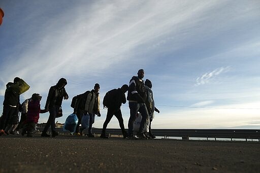 Migrants walk in Edirne, near the Turkish-Greek border on Friday, March 6, 2020. Thousands of refugees and other asylum-seekers have tried to enter Greece from the land and sea in the week since Turkey declared its previously guarded gateways to Europe open. (AP Photo/Emrah Gurel)