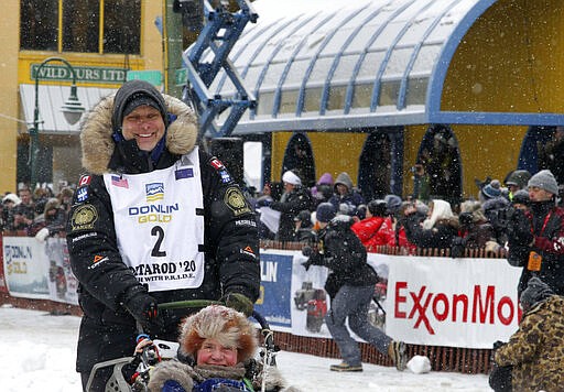 Musher Martin Massicotte of St-Tite, Quebec, Canada, leaves the start line during the ceremonial start of the Iditarod Trail Sled Dog Race Saturday, March 7, 2020, in Anchorage, Alaska. The real race starts March 8 about 50 miles north of Anchorage, with the winner expected in the Bering Sea coastal town of Nome about 10 or 11 days later. (AP Photo/Mark Thiessen)