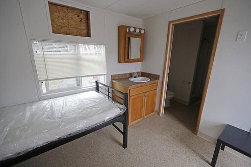 The interior of a two-bed temporary housing unit is shown Tuesday, March 3, 2020, at the site in South Seattle where King County will be placing several multi-unit housing modules to house patients undergoing treatment and isolation in response to the COVID-19 coronavirus. The units could be ready as soon as the end of the week. (AP Photo/Ted S. Warren)