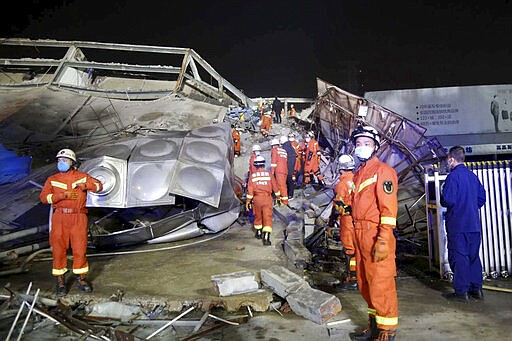 Rescuers work at the site of a collapsed five-story hotel building in Quanzhou city in southeast China's Fujian province Saturday, March 7, 2020. The hotel used for medical observation of people who had contact with coronavirus patients collapsed in southeastern China on Saturday, trapping dozens, state media reported. (Chinatopix Via AP)