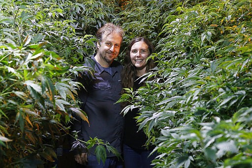 Chip and Jessica Baker pose for a photo at their marijuana nursery at Baker's Medical, Wednesday, Feb. 26, 2020, in Oklahoma City.  When voters in conservative Oklahoma approved medical marijuana in 2018, many thought the rollout would be ploddingly slow and burdened with bureaucracy. Instead, business is booming so much cannabis industry workers and entrepreneurs are moving to Oklahoma from states with more well-established pot cultures, like California, Colorado and Oregon.  (AP Photo/Sue Ogrocki)