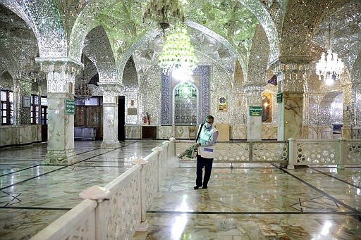 A man disinfects the shrine of the Shiite Saint Imam Abdulazim to help prevent the spread of the new coronavirus in Shahr-e-Ray, south of Tehran, Iran, Saturday, March, 7, 2020. (AP Photo/Ebrahim Noroozi)