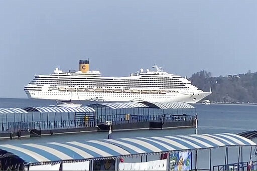 In this Friday, March 6, 2020 image taken from video, the Costa Fortuna cruise ship is seen near Phuket, Thailand. Thailand has denied entry to passengers and crew of the cruise ship that arrived at the popular Andaman Sea resort island of Phuket. (AP Photo)