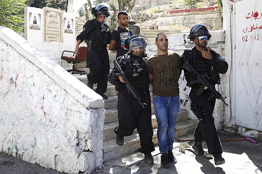 FILE - In this June 28, 2019 file photo, Israeli police arrest a Palestinian during clashes the Palestinian neighborhood of Issawiya in East Jerusalem, a day after a Palestinian was shot and killed by police during a protest in the same neighborhood. Nearly every day for the last nine months Israeli police have stormed into Issawiya in a campaign they say is needed to maintain law and order. Rights groups say that in addition to searching houses and issuing fines, they have detained hundreds of people &#151; some as young as 10, on suspicion of stone-throwing. The operations frequently ignite clashes, with local youths throwing rocks and firebombs. Residents and human rights groups say the provocative raids have created an atmosphere of terror, with parents afraid to let their children play outside. (AP Photo/Mahmoud Illean)