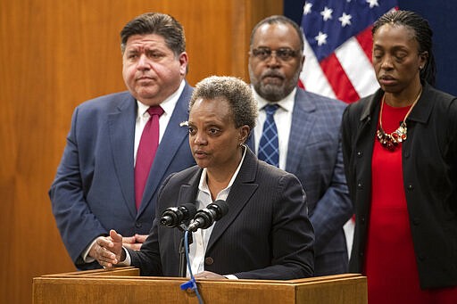 Mayor Lori Lightfoot, along with health and other elected officials, briefs reporters about the 6th case of the coronavirus in Illinois during a press conference at City Hall, Friday, March 6, 2020 in Chicago. (Tyler LaRiviere/Chicago Sun-Times via AP)