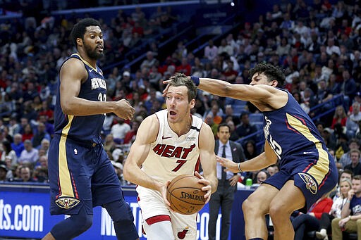 Miami Heat guard Goran Dragic (7) looks to pass the ball as New Orleans Pelicans center Derrick Favors (22) and guard Frank Jackson (15) defend during the first half of an NBA basketball game in New Orleans, Friday, March 6, 2020. (AP Photo/Rusty Costanza)