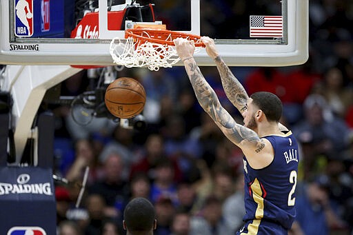 New Orleans Pelicans guard Lonzo Ball dunks during the first half of an NBA basketball game against the Miami Heat in New Orleans, Friday, March 6, 2020. (AP Photo/Rusty Costanza)