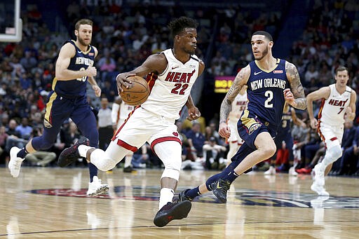 Miami Heat forward Jimmy Butler (22) drives to the basket as New Orleans Pelicans guard Lonzo Ball (2) defends during the first half of an NBA basketball game in New Orleans, Friday, March 6, 2020. (AP Photo/Rusty Costanza)