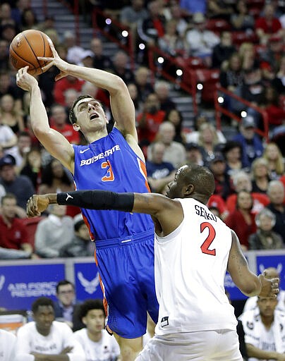 Boise State's Justinian Jessup (3) tries to shoot as San Diego State's Adam Seiko (2) defends during the first half of an NCAA college basketball game in the Mountain West Conference men's tournament Friday, March 6, 2020, in Las Vegas. (AP Photo/Isaac Brekken)