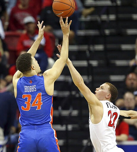 Boise State's Alex Hobbs (34) shoots as San Diego State's Malachi Flynn (22) defends during the second half of an NCAA college basketball game in the Mountain West Conference men's tournament Friday, March 6, 2020, in Las Vegas. (AP Photo/Isaac Brekken)