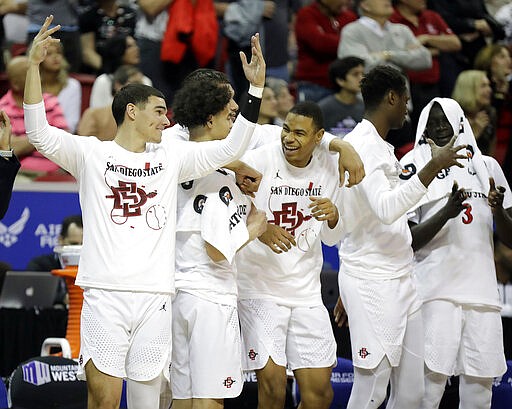 The San Diego State bench reacts during the second half of the team's NCAA college basketball game against Boise State in the Mountain West Conference men's tournament Friday, March 6, 2020, in Las Vegas. (AP Photo/Isaac Brekken)