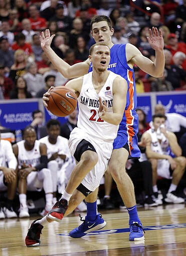 San Diego State's Malachi Flynn (22) drives to the hoop as Boise State's Justinian Jessup defends during the second half of an NCAA college basketball game in the Mountain West Conference men's tournament Friday, March 6, 2020, in Las Vegas. (AP Photo/Isaac Brekken)