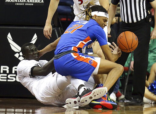 Boise State's Derrick Alston (21) and San Diego State's Aguek Arop (3) become entangled during the second half of an NCAA college basketball game in the Mountain West Conference men's tournament Friday, March 6, 2020, in Las Vegas. (AP Photo/Isaac Brekken)