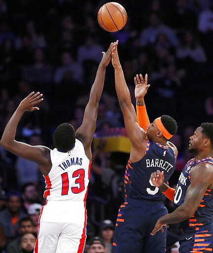 Detroit Pistons guard Khyri Thomas (13) defends New York Knicks guard RJ Barrett (9) as Barrett shoots during the first half of an NBA basketball game in New York, Sunday, March 8, 2020. Knicks forward Julius Randle (30) looks on, left. (AP Photo/Kathy Willens)