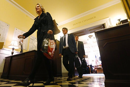 Del. Amanda Batten, R-James City County, left, leads other Delegates out of the chamber after the House adjourned  until Thursday at the Capitol Sunday March 8 , 2020, in Richmond, Va. The Legislature will take up the budget bills as well as judges on Thursday. (AP Photo/Steve Helber)