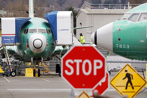 FILE - In this Monday, Dec. 16, 2019 file photo, Boeing 737 MAX jets sit parked in Renton, Wash. When air safety investigators release an interim report on the crash of an Ethiopian Airlines Boeing 737 Max sometime before Tuesday, March 10, 2020, the one-year anniversary of the crash, they are likely to place the blame on the jet's automated flight control system as well as on the pilots and their training, but it's unclear yet which side will bear the brunt. (AP Photo/Elaine Thompson, File)