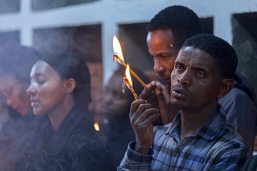 Ethiopian relatives of some of the crash victims light candles and gather at an anniversary memorial service to remember those who died when Ethiopian Airlines flight ET302, a Boeing 737 Max, crashed shortly after takeoff on March 10, 2019 killing all 157 on board, at the Holy Trinity Cathedral in Addis Ababa, Ethiopia Sunday, March 8, 2020. (AP Photo/Mulugeta Ayene)