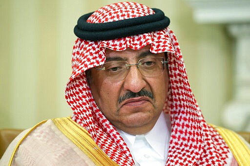 FILE - This May 13, 2015 file photo, shows then Saudi Arabian Crown Prince Mohammed bin Nayef during a meeting with President Barack Obama in the Oval Office of the White House, in Washington. King Salman was shown in state media Sunday, March 8, 2020, in apparent good health and working, just days after the arrest of Mohammed bin Nayef and another senior prince triggered speculation about a possible coup attempt or a sudden deterioration in the king's health. (AP Photo/Jacquelyn Martin, File)