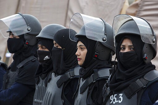 Pakistani police officers stand guard during a rally for International Women's Day in Islamabad, Pakistan, Sunday, March 8, 2020. Pakistanis held rallies across the country. Officially recognized by the United Nations in 1977, it is celebrated around the world on March 8. (AP Photo/B.K. Bangash)