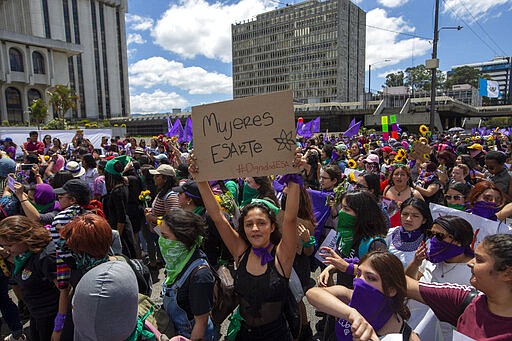 Women march in front of the Supreme Court during International Women's Day in Guatemala City, Sunday, March 8, 2020. (AP Photo/Moises Castillo)