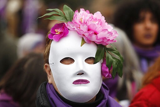 A protester takes part in a march on International Women's Day in Madrid, Spain, Sunday, March 8, 2020, Thousands of women are marching in Madrid and other Spanish cities as part of International Women's Day. (AP Photo/Paul White)