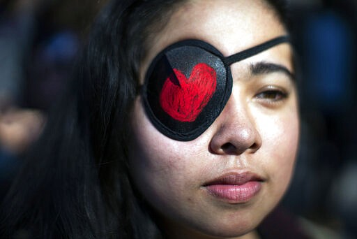 A woman covers her eye in solidarity with the Chilean protestors as people participate in a rally celebrating International Women's Day at Washington Square Park in New York, Sunday, March 8, 2020.&#160;(AP Photo/Eduardo Munoz Alvarez)