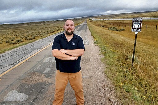 In this Sept. 25, 2017, photo, Bryan Farr, president of the Historic Route 20 Association in Chester, Mass, stands on an original alignment of U.S. Route 20 near Orin, Wy. Highway 20 was moved to the neighboring Interstate 25 where speed limits are set at 80 mph. &#147;Almost every town has a story to tell,&#148; Farr, said.  (Bryan Farr via AP)