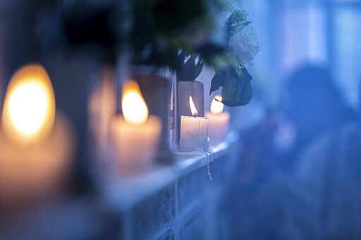 Candles are lit on a memorial wall during an anniversary memorial service to remember those who died when Ethiopian Airlines flight ET302, a Boeing 737 Max, crashed shortly after takeoff on March 10, 2019 killing all 157 on board, at the Holy Trinity Cathedral in Addis Ababa, Ethiopia Sunday, March 8, 2020. (AP Photo/Mulugeta Ayene)