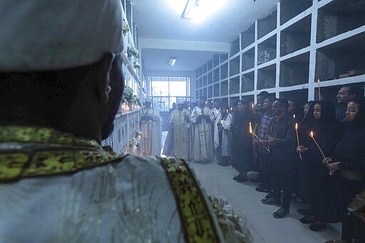 Ethiopian relatives of some of the crash victims light candles and gather at an anniversary memorial service to remember those who died when Ethiopian Airlines flight ET302, a Boeing 737 Max, crashed shortly after takeoff on March 10, 2019 killing all 157 on board, at the Holy Trinity Cathedral in Addis Ababa, Ethiopia Sunday, March 8, 2020. (AP Photo/Mulugeta Ayene)