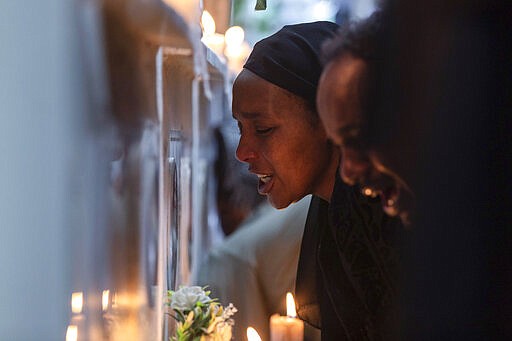 Ethiopian relatives of some of the crash victims light candles and gather at an anniversary memorial service to remember those who died when Ethiopian Airlines flight ET302, a Boeing 737 Max, crashed shortly after takeoff on March 10, 2019 killing all 157 on board, at the Holy Trinity Cathedral in Addis Ababa, Ethiopia Sunday, March 8, 2020. (AP Photo/Mulugeta Ayene)