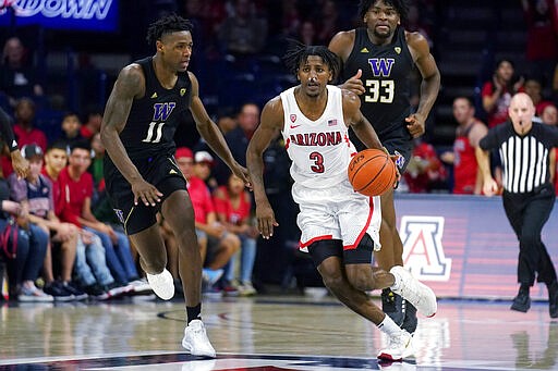 Arizona guard Dylan Smith (3) drives past Washington guard Nahziah Carter (11) during the second half of an NCAA college basketball game Saturday, March 7, 2020, in Tucson, Ariz. Washington won 69-63. (AP Photo/Rick Scuteri)