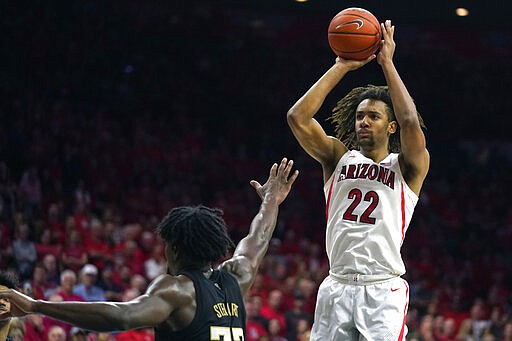 Arizona forward Zeke Nnaji (22) shoots over Washington forward Isaiah Stewart during the second half of an NCAA college basketball game Saturday, March 7, 2020, in Tucson, Ariz. Washington won 69-63. (AP Photo/Rick Scuteri)