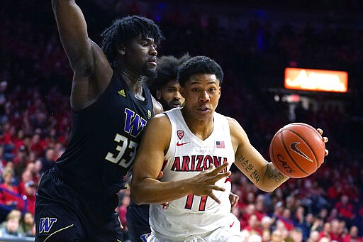 Arizona forward Ira Lee (11) drives on Washington forward Isaiah Stewart during the second half of an NCAA college basketball game Saturday, March 7, 2020, in Tucson, Ariz. Washington won 69-63. (AP Photo/Rick Scuteri)