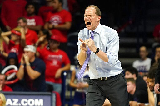 Washington coach Mike Hopkins yells to players during the second half of the team's NCAA college basketball game against Arizona on Saturday, March 7, 2020, in Tucson, Ariz. Washington won 69-63. (AP Photo/Rick Scuteri)