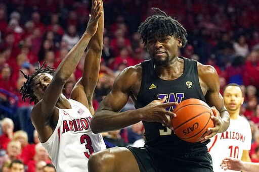 CORRECTS TO WASHINGTON FORWARD ISAIAH STEWART, INSTEAD OF WASHINGTON STATE'S BRANDTON CHATFIELD - Washington forward Isaiah Stewart drives on Arizona guard Dylan Smith (3) during the first half of an NCAA college basketball game Saturday, March 7, 2020, in Tucson, Ariz. Smith broke his nose on the play. (AP Photo/Rick Scuteri)