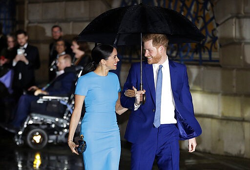 FILE - In this Thursday, March 5, 2020 file photo, Britain's Prince Harry and Meghan, the Duke and Duchess of Sussex arrive at the annual Endeavour Fund Awards in London. Prince Harry and his wife, Meghan, are fulfilling their last royal commitment Monday March 9, 2020 when they appear at the annual Commonwealth Service at Westminster Abbey. It is the last time they will be seen at work with the entire Windsor clan before they fly off into self-imposed exile in North America. (AP Photo/Kirsty Wigglesworth, file)