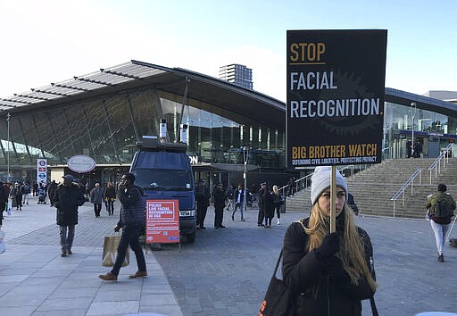 Rights campaigner Silkie Carlo demonstrates in front of a mobile police facial recognition facility outside a shopping centre in London Tuesday Feb. 11, 2020, &#147;We don't accept this. This isn't what you do in a democracy,&quot; said Carlo, director of privacy campaign group Big Brother Watch. London police started using facial recognition surveillance cameras mounted on a blue police van on Tuesday to automatically scan for wanted people, as authorities adopt the controversial technology that has raised concerns about increased surveillance and erosion of privacy. (AP Photo/Kelvin Chan)