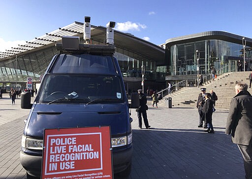 A mobile police facial recognition facility outside a shopping centre in London Tuesday Feb. 11, 2020, &#147;We don't accept this. This isn't what you do in a democracy,&quot; said Silkie Carlo, director of privacy campaign group Big Brother Watch, who are demonstrating against the surveillance.  London police started using facial recognition surveillance cameras mounted on a blue police van on Tuesday to automatically scan for wanted people, as authorities adopt the controversial technology that has raised concerns about increased surveillance and erosion of privacy. (AP Photo/Kelvin Chan)