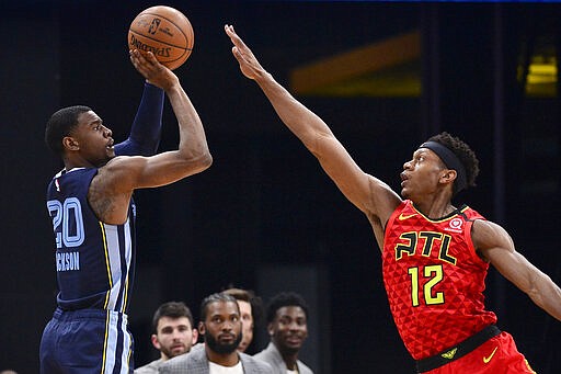 Memphis Grizzlies guard Josh Jackson (20) shoots against Atlanta Hawks forward De'Andre Hunter (12) in the first half of an NBA basketball game Saturday, March 7, 2020, in Memphis, Tenn. (AP Photo/Brandon Dill)