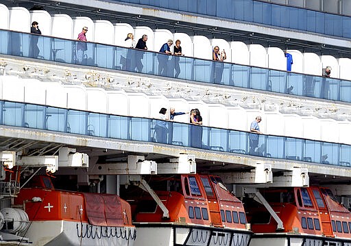 Passengers look out from balconies aboard the Grand Princess as it cruises a holding pattern about 25 miles off the coast of San Francisco on Sunday, March 8, 2020. The ship is expected to dock in Oakland in the east San Francisco Bay on Monday. California Gov. Gavin Newsom and the mayor of Oakland sought Sunday to reassure the public that none of the passengers from the ship with multiple cases of the new coronavirus will be released into the public before undergoing a 14-day quarantine. (AP Photo/Noah Berger)