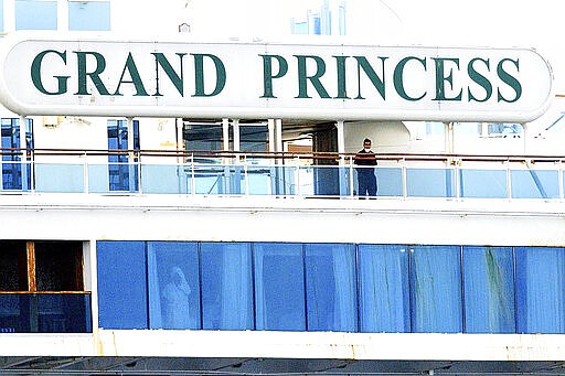 A man wears a mask aboard the Grand Princess as it maintains a holding pattern about 25 miles off the coast of San Francisco on Sunday, March 8, 2020. The cruise ship is scheduled to dock at the Port of Oakland on Monday for COVID-19 quarantine after 21 people tested positive for the virus. (AP Photo/Noah Berger)