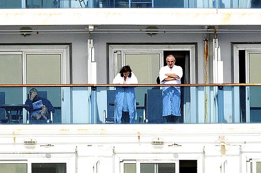 Passengers look out from balconies aboard the Grand Princess as it cruises a holding pattern about 25 miles off the coast of San Francisco on Sunday, March 8, 2020. The ship is expected to dock in Oakland in the east San Francisco Bay on Monday. California Gov. Gavin Newsom and the mayor of Oakland sought Sunday to reassure the public that none of the passengers from the ship with multiple cases of the new coronavirus will be released into the public before undergoing a 14-day quarantine. (AP Photo/Noah Berger)