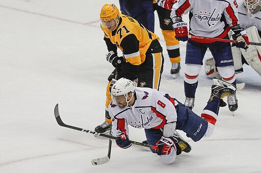 Washington Capitals' Alex Ovechkin (8) tumbles to the ice in front of Pittsburgh Penguins' Evgeni Malkin (71) after clearing the puck during the third period of an NHL hockey game, Saturday, March 7, 2020, in Pittsburgh. The Capitals won 5-2. (AP Photo/Keith Srakocic)