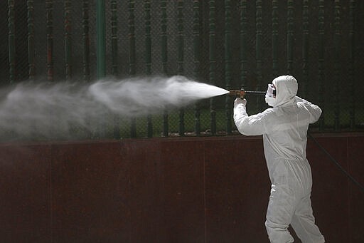 Iraqi workers spray disinfectant as a precaution against the coronavirus in the shrine of Imam Ali in Najaf, Iraq, Sunday, March 8, 2020. (AP Photo/Anmar Khalil)