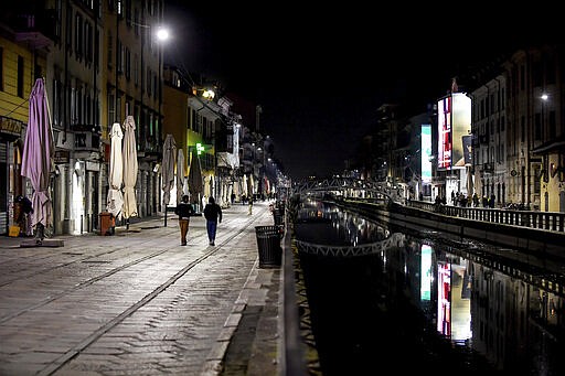 The Navigli district of Milan, one of the area of night life in Milan, is almost deserted after most bars were closed by the last decisions of the government trying to face the coronavirus emergency, in Milan, Sunday, March 8, 2020. (Claudio Furlan/LaPresse via AP)